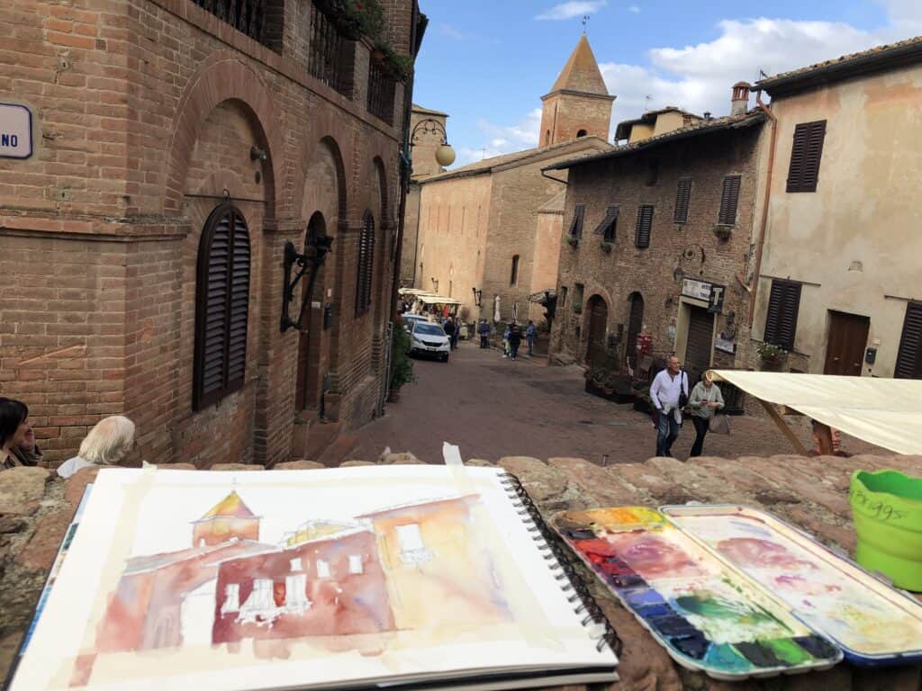 Group of artists painting outdoors together, capturing real-life inspiration and immersing themselves in the beauty of the surrounding environment during the experience of painting outdoors with a group