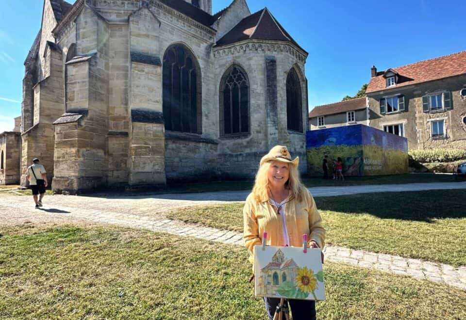 Cindy Briggs painting en plein air in front of the church at Auvers-sur-Oise, France