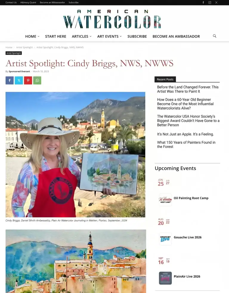 Cindy Briggs holding her watercolor painting outdoors with mountains in background.
