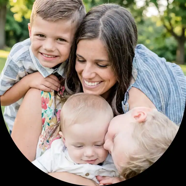 Happy family enjoying outdoor time with children and mother smiling.