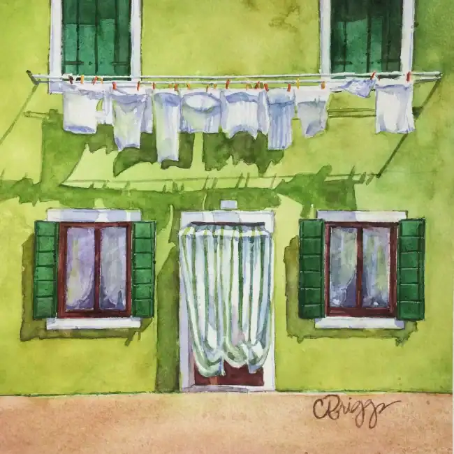 Watercolor painting of a green building with laundry hanging outside.