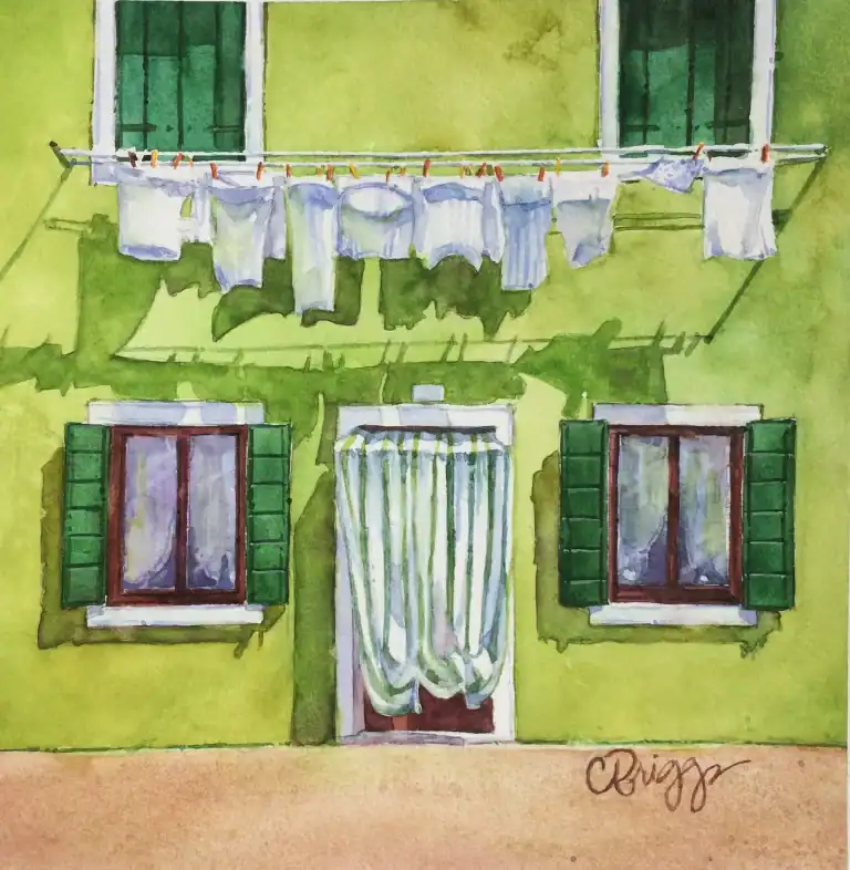 Watercolor painting of a green building with laundry hanging outside.