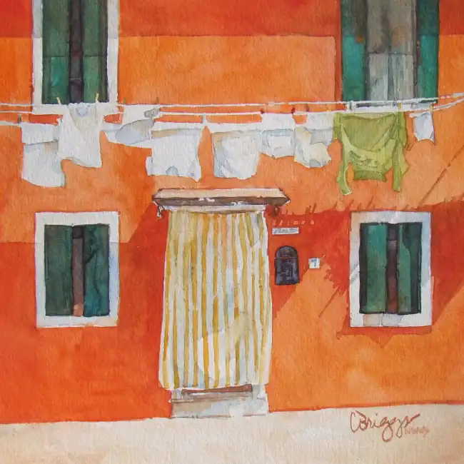 Colorful watercolor painting of an orange building with laundry hanging outside.